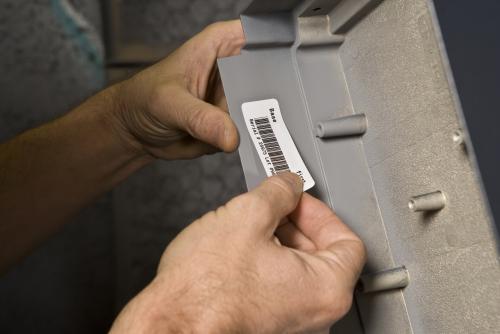 Label Being Placed on Equipment