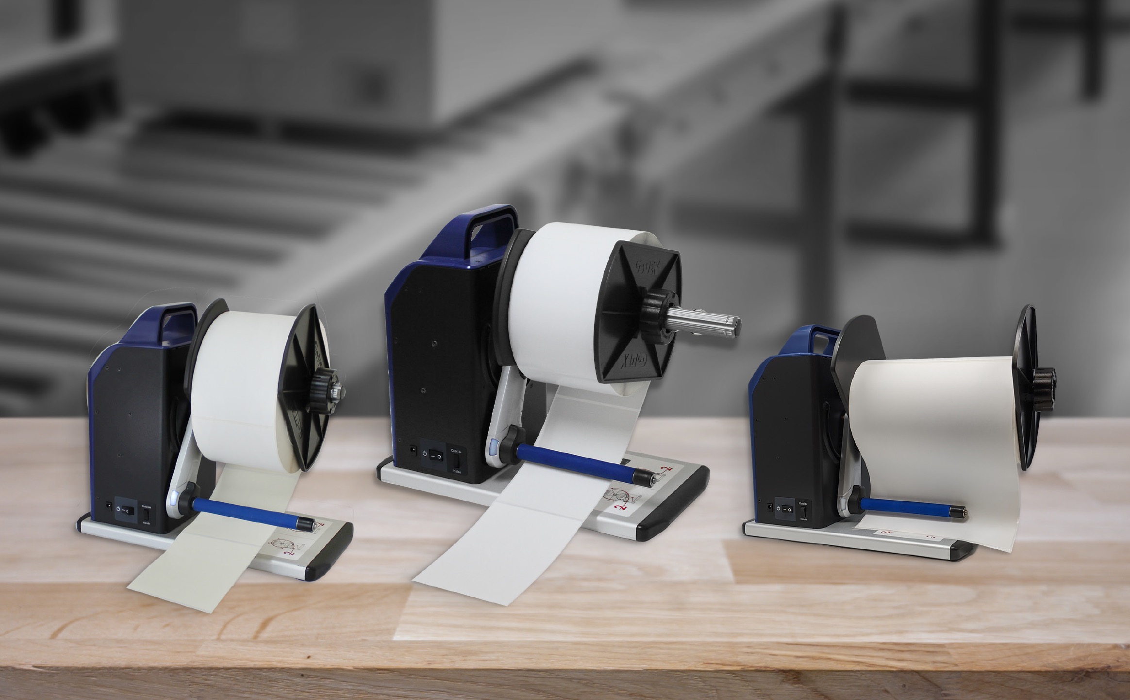 GoDEX T-Series label rewinders T10 T20 T30 displayed on a workbench — universal label rewinder compatible with all thermal printer brands